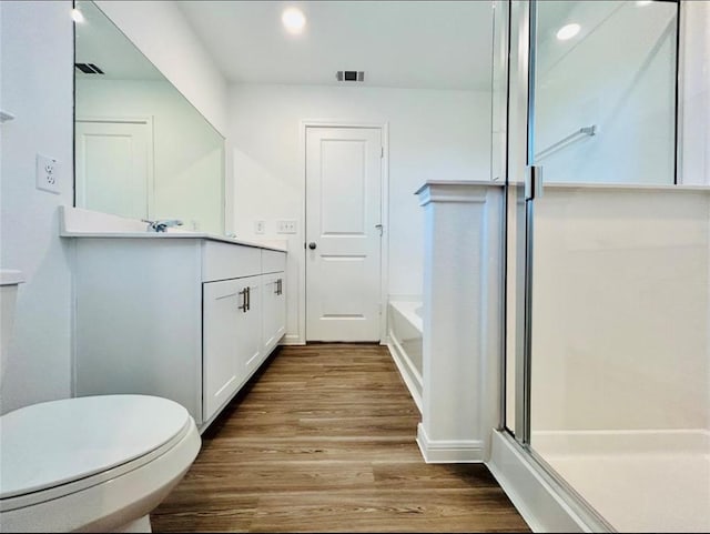 1009 Laguna Cove Dr, Katy, TX 77493 - bathroom with vanity, wood finished floors, recessed lighting, a bath, and a shower with shower door