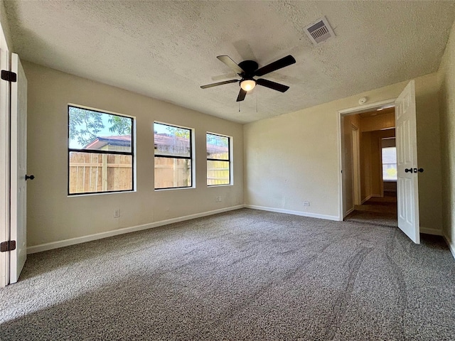 609 S Gray Ave, West Columbia, TX 77486 - carpeted empty room featuring a textured ceiling and a ceiling fan