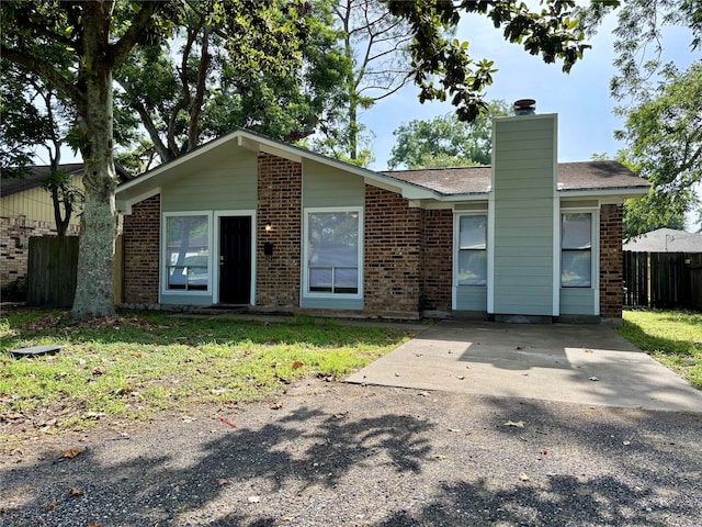 609 S Gray Ave, West Columbia, TX 77486 - view of front facade with brick siding and a chimney