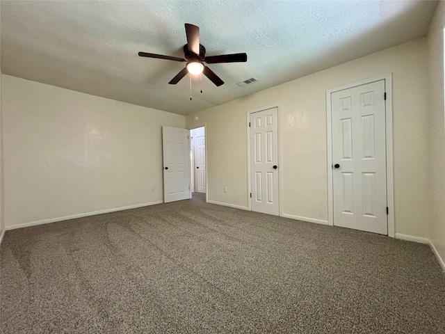 609 S Gray Ave, West Columbia, TX 77486 - unfurnished bedroom featuring carpet flooring, a textured ceiling, and ceiling fan