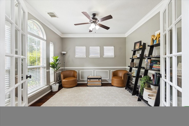 1402 Sullivan Springs Dr, Katy, TX 77494 - living area with crown molding, french doors, ceiling fan, wood finished floors, and a wainscoted wall