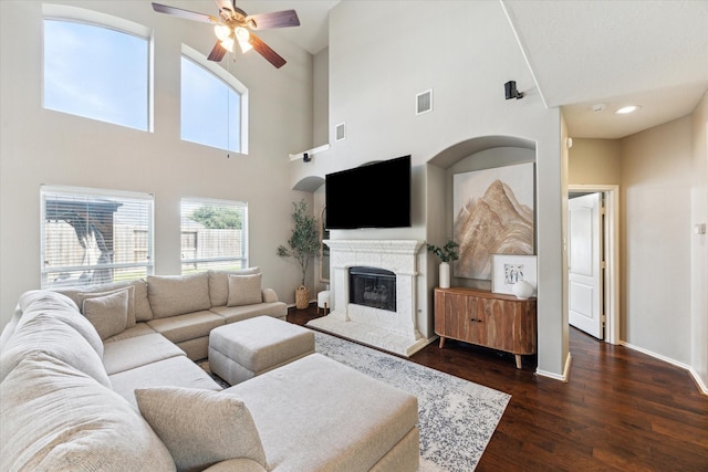1402 Sullivan Springs Dr, Katy, TX 77494 - living room featuring ceiling fan, dark wood-style floors, a glass covered fireplace, and a high ceiling