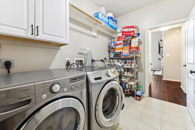 1402 Sullivan Springs Dr, Katy, TX 77494 - laundry area featuring cabinet space, independent washer and dryer, and tile patterned flooring