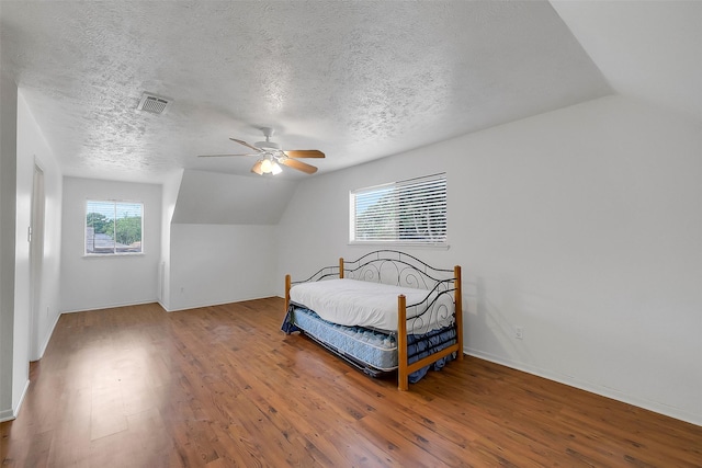 21307 Park Willow Dr, Katy, TX 77450 - bedroom featuring wood finished floors, vaulted ceiling, a ceiling fan, and a textured ceiling