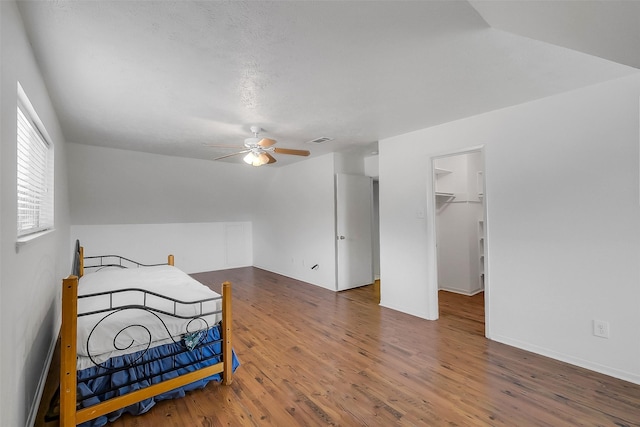 21307 Park Willow Dr, Katy, TX 77450 - bedroom featuring wood finished floors, a walk in closet, and a ceiling fan
