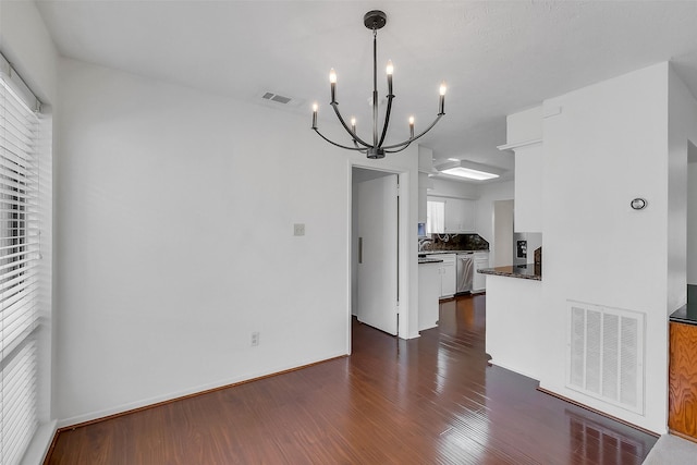 21307 Park Willow Dr, Katy, TX 77450 - kitchen with a chandelier, dark countertops, stainless steel dishwasher, white cabinets, and dark wood-type flooring