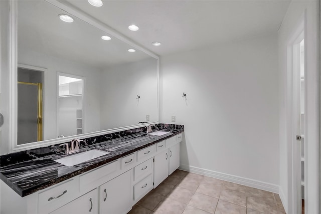 21307 Park Willow Dr, Katy, TX 77450 - bathroom featuring double vanity, a stall shower, recessed lighting, tile patterned floors, and a walk in closet