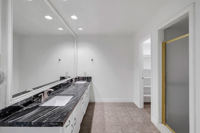 21307 Park Willow Dr, Katy, TX 77450 - full bathroom with double vanity, a stall shower, recessed lighting, tile patterned flooring, and a spacious closet