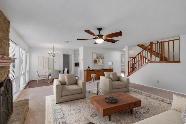 21307 Park Willow Dr, Katy, TX 77450 - living room featuring stairs, ceiling fan, a chandelier, a fireplace, and carpet flooring