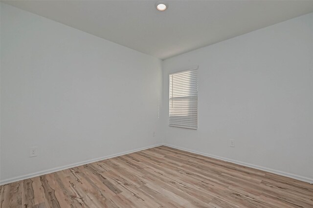 22156 Juniper Crossing Dr, New Caney, TX 77357 - spare room with light wood-type flooring and baseboards
