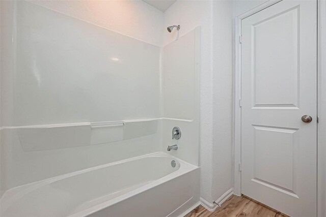 22156 Juniper Crossing Dr, New Caney, TX 77357 - bathroom featuring wood finished floors and shower / tub combination