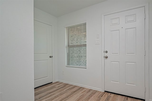 22156 Juniper Crossing Dr, New Caney, TX 77357 - foyer entrance with light wood-style floors and baseboards