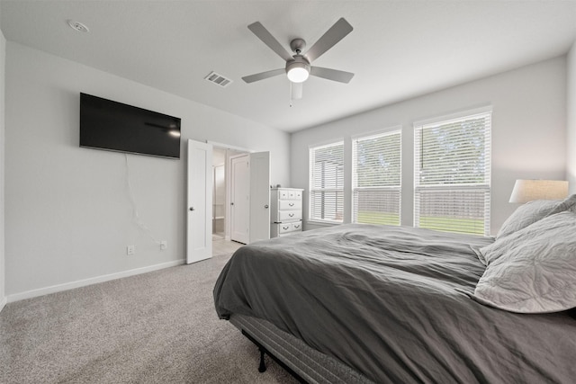 507 Winburn Tide Ln, La Porte, TX 77571 - bedroom with light carpet, ceiling fan, and ensuite bath