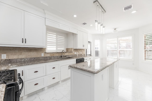 20411 Avery Point Dr, Katy, TX 77449 - kitchen with stainless steel range with gas cooktop, a center island, light marble finish floors, recessed lighting, and light stone counters