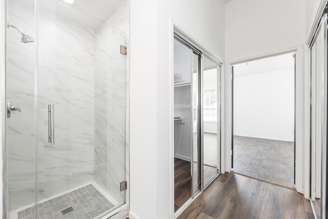 20411 Avery Point Dr, Katy, TX 77449 - bathroom featuring a marble finish shower, wood finished floors, and a spacious closet