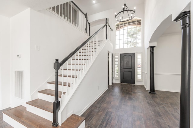 20411 Avery Point Dr, Katy, TX 77449 - foyer featuring arched walkways, wood finished floors, a chandelier, a high ceiling, and stairs