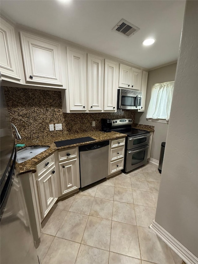 2330 Lakewood Yacht Club Dr Unit 7, Seabrook, TX 77586 - kitchen featuring stainless steel appliances, decorative backsplash, dark stone counters, and light tile patterned flooring