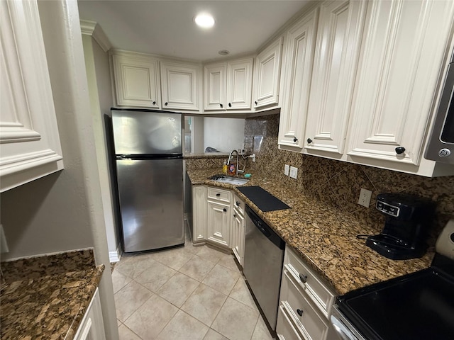 2330 Lakewood Yacht Club Dr Unit 7, Seabrook, TX 77586 - kitchen with stainless steel appliances, tasteful backsplash, dark stone counters, white cabinetry, and light tile patterned floors