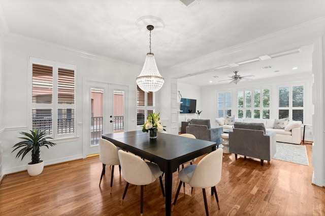817 Rosine St, Houston, TX 77019 - dining area featuring light wood-type flooring, a chandelier, ornamental molding, and a ceiling fan