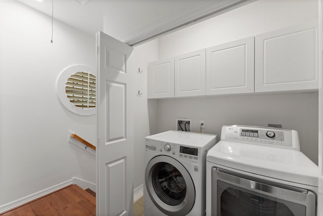 817 Rosine St, Houston, TX 77019 - laundry room with cabinet space, independent washer and dryer, and wood finished floors