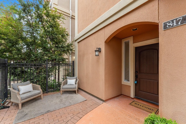 817 Rosine St, Houston, TX 77019 - doorway to property with stucco siding and a patio area