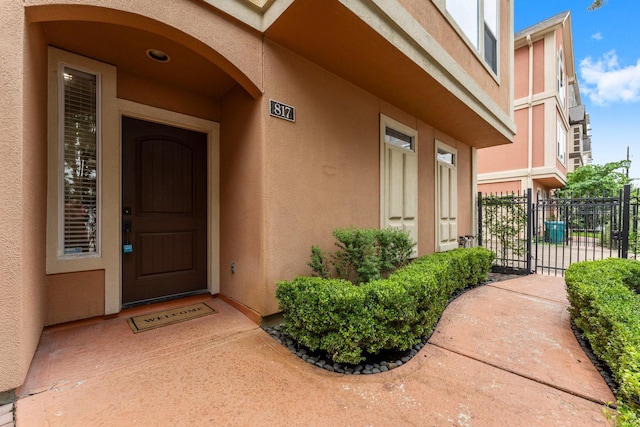 817 Rosine St, Houston, TX 77019 - doorway to property featuring stucco siding