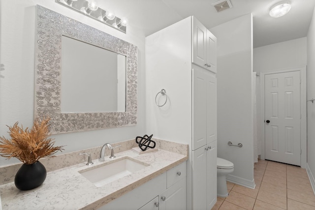 817 Rosine St, Houston, TX 77019 - bathroom with tile patterned floors, vanity, and a closet