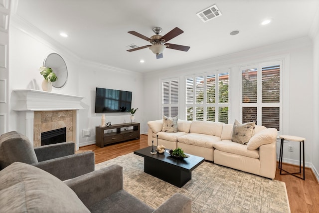 817 Rosine St, Houston, TX 77019 - living area featuring a ceiling fan, crown molding, wood finished floors, a tile fireplace, and recessed lighting