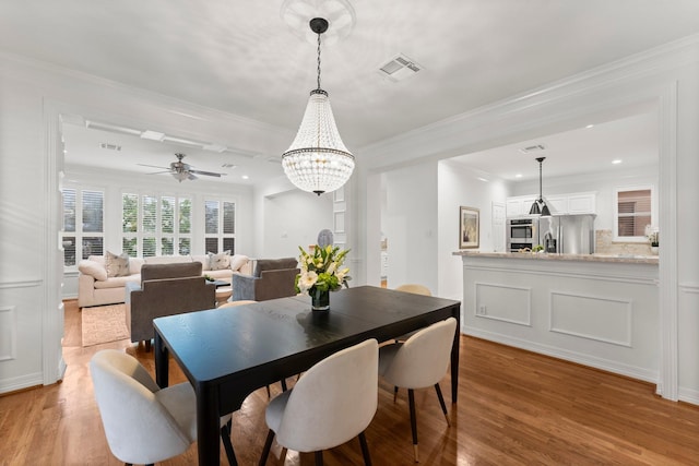 817 Rosine St, Houston, TX 77019 - dining area with light wood-type flooring, a chandelier, crown molding, ceiling fan, and recessed lighting