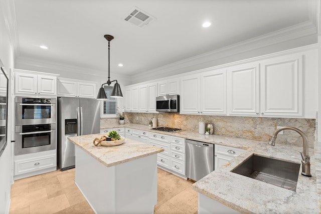 817 Rosine St, Houston, TX 77019 - kitchen featuring stainless steel appliances, a kitchen island, crown molding, backsplash, and white cabinets