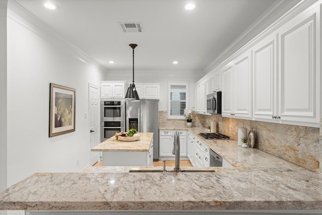 817 Rosine St, Houston, TX 77019 - kitchen with appliances with stainless steel finishes, a kitchen island, light stone counters, backsplash, and ornamental molding