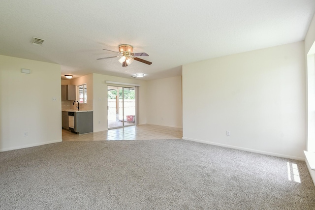 1117 Delores St, Kemah, TX 77565 - unfurnished living room with a ceiling fan and light carpet