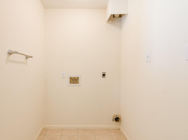 1117 Delores St, Kemah, TX 77565 - laundry area featuring hookup for an electric dryer, light tile patterned flooring, and hookup for a washing machine