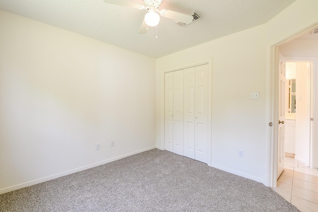 1117 Delores St, Kemah, TX 77565 - unfurnished bedroom with light carpet, a closet, and a ceiling fan