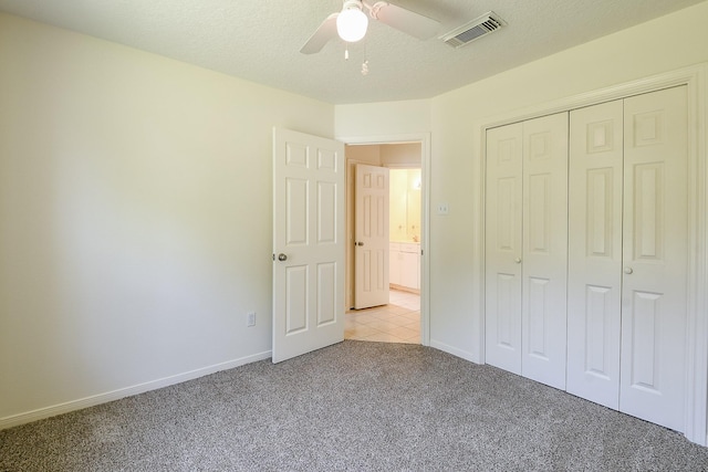 1117 Delores St, Kemah, TX 77565 - unfurnished bedroom with light colored carpet, a closet, and ceiling fan