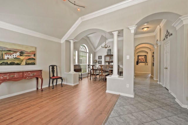 13615 Mierwood Manor Dr, Cypress, TX 77429 - entrance foyer featuring vaulted ceiling, ornate columns, crown molding, arched walkways, and light wood finished floors