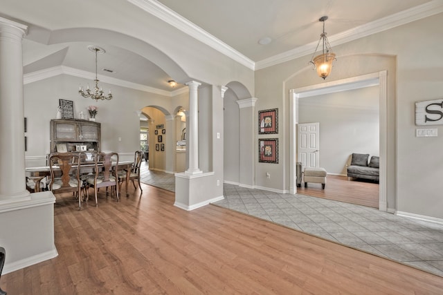 13615 Mierwood Manor Dr, Cypress, TX 77429 - dining room with arched walkways, light wood-style floors, decorative columns, and ornamental molding