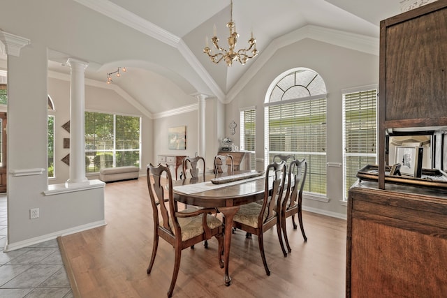 13615 Mierwood Manor Dr, Cypress, TX 77429 - dining room with decorative columns, lofted ceiling, healthy amount of natural light, and light wood-style floors
