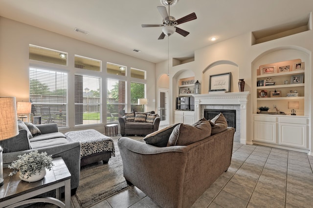 13615 Mierwood Manor Dr, Cypress, TX 77429 - living area featuring built in shelves, ceiling fan, plenty of natural light, and a fireplace