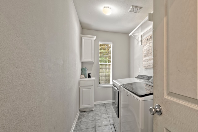 13615 Mierwood Manor Dr, Cypress, TX 77429 - washroom with separate washer and dryer, cabinet space, and light tile patterned flooring