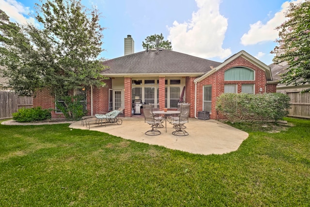 13615 Mierwood Manor Dr, Cypress, TX 77429 - rear view of house with brick siding, a chimney, a patio, and a shingled roof