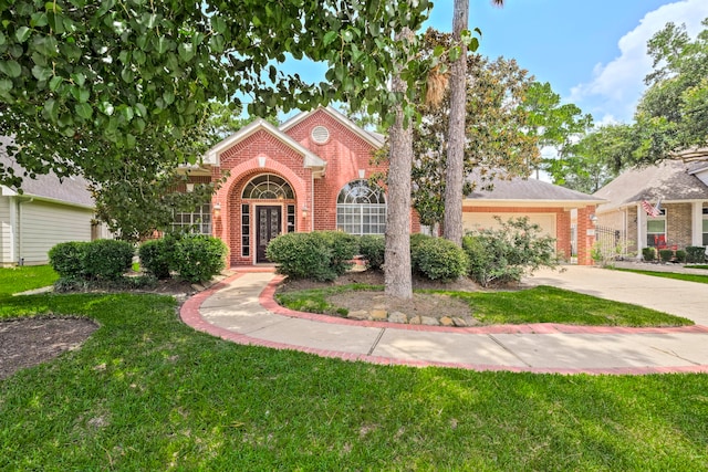 13615 Mierwood Manor Dr, Cypress, TX 77429 - view of front of house featuring brick siding, an attached garage, a front yard, and concrete driveway