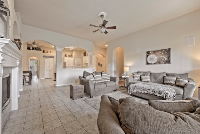 13615 Mierwood Manor Dr, Cypress, TX 77429 - living area with a ceiling fan, arched walkways, and light tile patterned floors