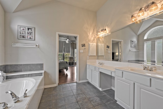 13615 Mierwood Manor Dr, Cypress, TX 77429 - full bath featuring lofted ceiling, double vanity, connected bathroom, a garden tub, and tile patterned floors