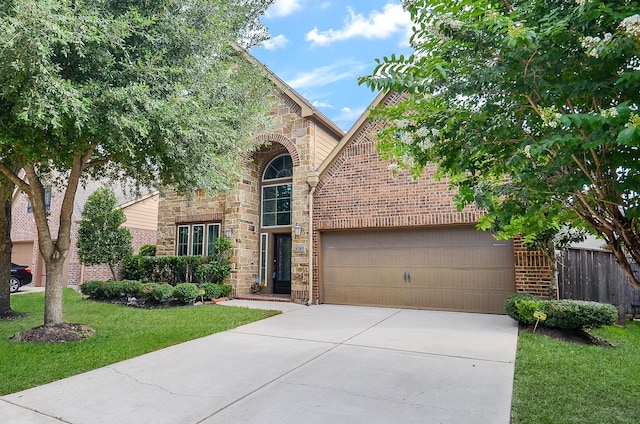 28722 Maple Red Dr, Katy, TX 77494 - view of front of home featuring concrete driveway, an attached garage, brick siding, and stone siding