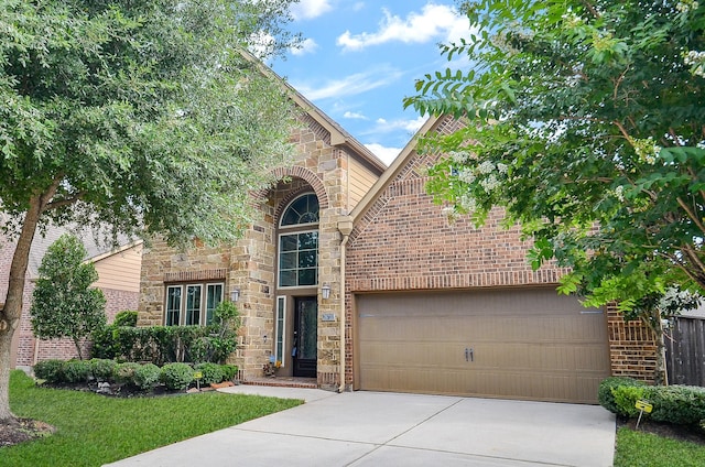 28722 Maple Red Dr, Katy, TX 77494 - view of front of home featuring driveway, stone siding, brick siding, and an attached garage