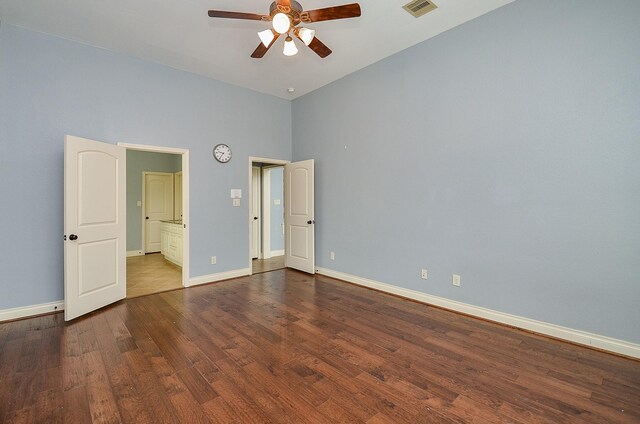28722 Maple Red Dr, Katy, TX 77494 - unfurnished bedroom with dark wood-style flooring, a towering ceiling, connected bathroom, and ceiling fan