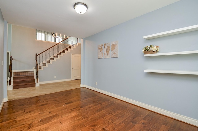 28722 Maple Red Dr, Katy, TX 77494 - unfurnished living room with stairs and wood finished floors