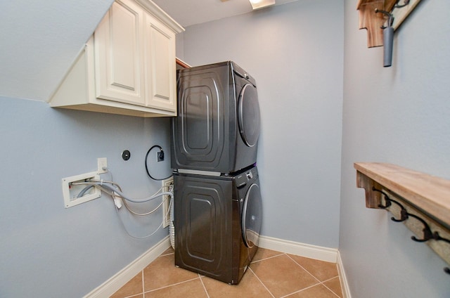28722 Maple Red Dr, Katy, TX 77494 - laundry area featuring cabinet space, estacked washer and dryer, and light tile patterned floors