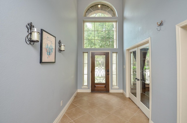 28722 Maple Red Dr, Katy, TX 77494 - entrance foyer featuring french doors, healthy amount of natural light, light tile patterned floors, and a high ceiling